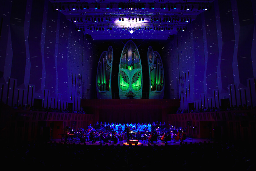 An orchestral concert of music from the *Madoka Magica* movies. This picture was taken during the performance of “Hikarifuru” during the second half of the concert. They made use of light by using a mirror ball. 20