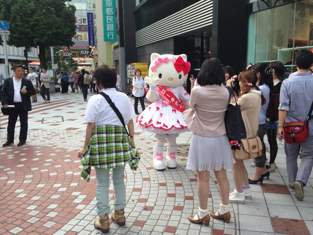 Hello Kitty gives a speech to passersby on the streets of Japan.  1