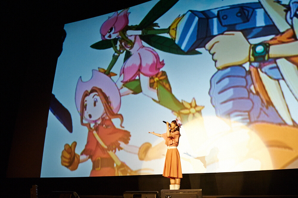 AiM also plays the voice of Mimi Tachikawa, who was is shown on the screen behind her. 7