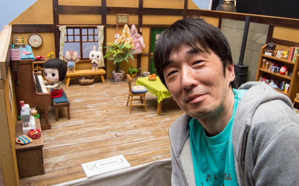 Tsuneo Gouda, who took part in the production of *By Your Side*, with one of the dioramas. 6