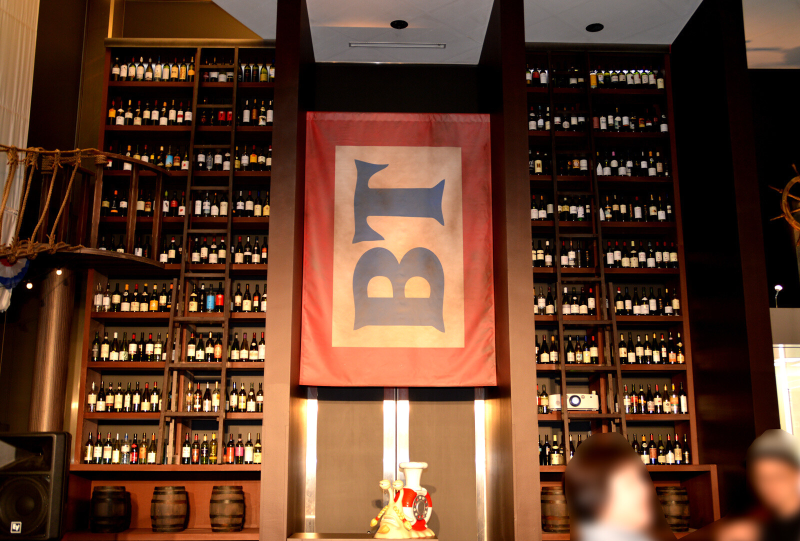 A wine shelf reaching up to the ceiling. Huh? What is that in the middle? 17