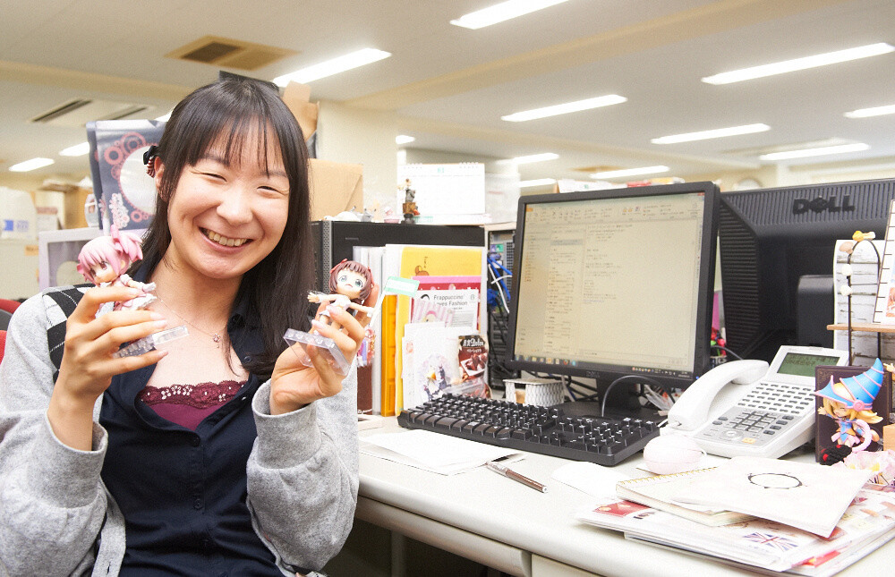 Ms. Hamada  holds up one of her favorite figures. It’s shy smile is charming. 4