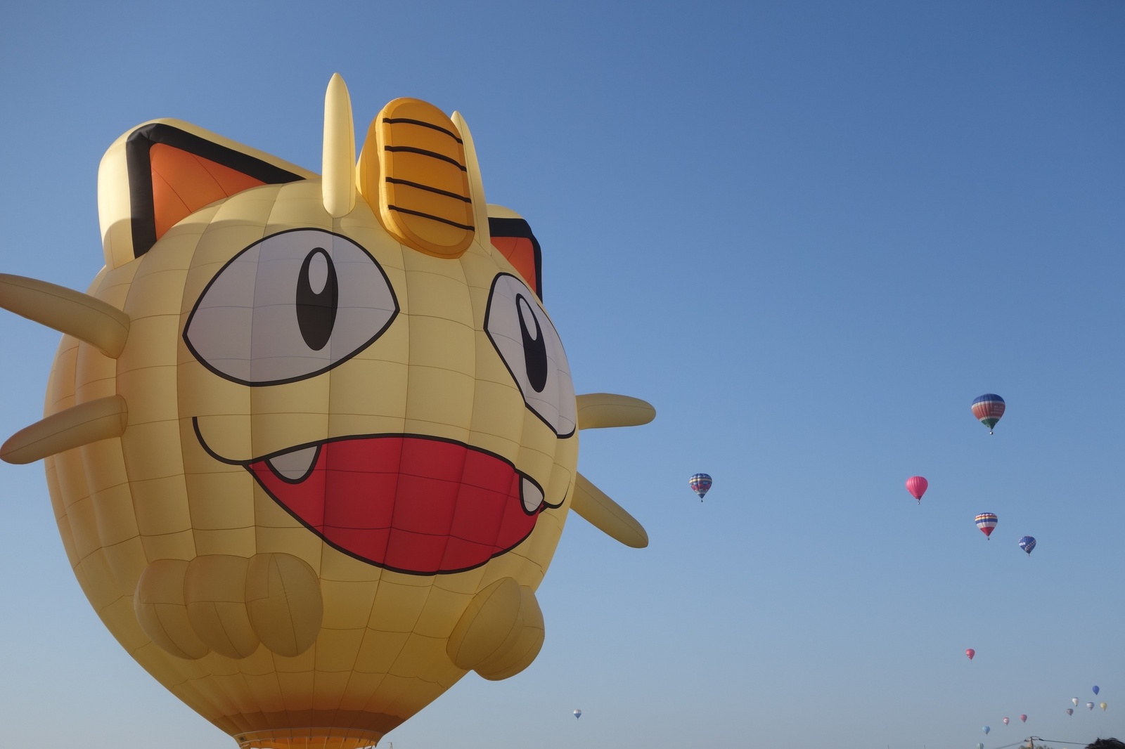 Join Team Rocket in Their Gigantic Meowth Balloon Over Saga!